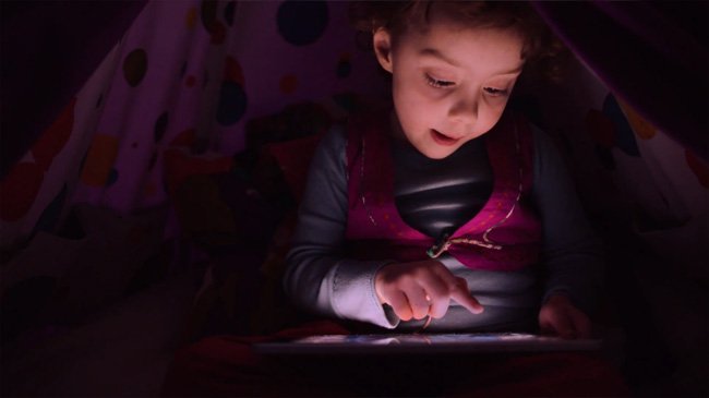 Apple advertisement of a small child
holding an iPad